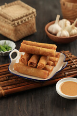 Chinese Egg Rolls, Deep Fried Chives Spring Rolls or Gui Chai on a Ceramic Plate.