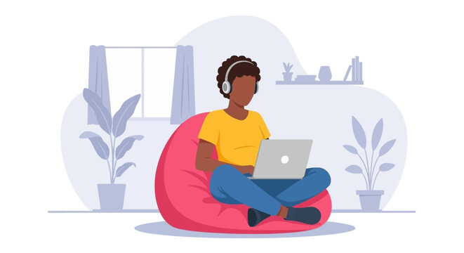 Young person comfortably working or studying remotely on a laptop with headphones at home. Ideal for online learning, telecommuting, and digital lifestyle concepts.