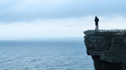 silhouette of a man standing on a rock