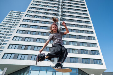 Girl practices skiing tricks on a trampoline. 