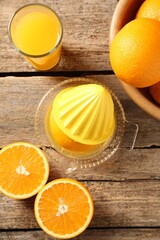 Tasty orange juice, fresh fruits and juicer on wooden table, flat lay
