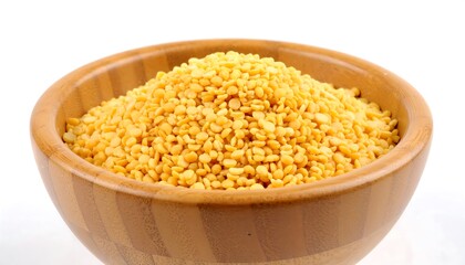 Pile of yellow split peas in a wooden bowl.