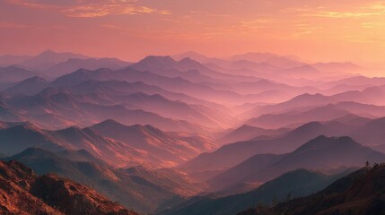 Sunrise over layers of blue mountains with mist and a colorful sky creates a majestic view