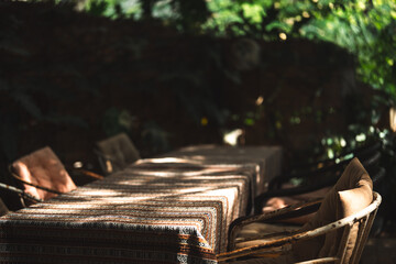 A cozy outdoor cafe surrounded by lush green garden, wooden pergola walkway, rustic architecture,...