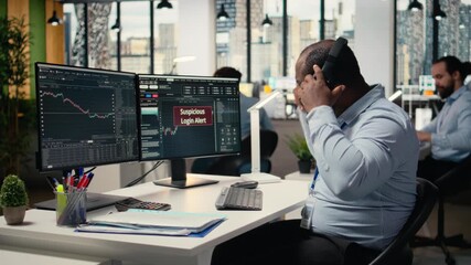 Trader in office spots suspicious login attempt warning on trading platform dashboard, working to fix error. Stockbroker seeing security alert notification of unauthorized login activity, camera A - Powered by Adobe
