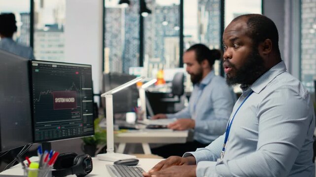 Trader frightened by security alert on PC after hacker uses exploit to penetrate systems. Brokerage company worker responds to cyberattack, protecting client account from unauthorized access, camera B