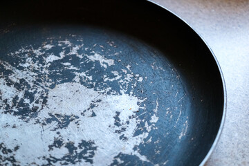 Old frying pan with damaged non-stick coating showing.frying pan with PFOA substance, possible...