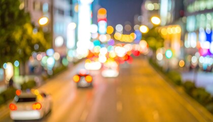 A blurred urban street scene at night, showcasing colorful bokeh lights from illuminated buildings and vehicles.