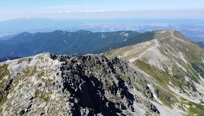 High mountain ridge with rocky terrain and distant valley views.
