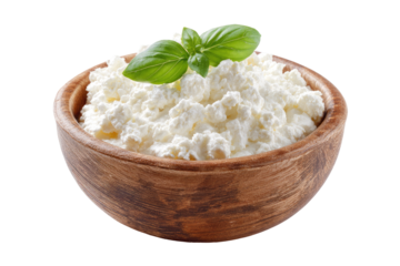 Creamy ricotta cheese in a wooden bowl, garnished with fresh basil leaves