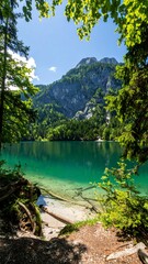 Mountain lake scenery, lush green trees, clear water