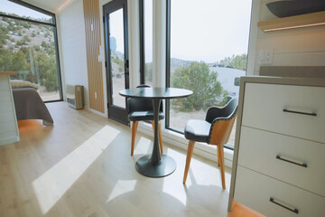 Cozy dining area with modern furniture and scenic views of nature