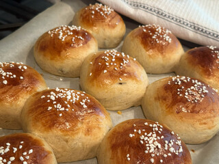 Closeup of freshly home baked sweet buns on a cookie sheet. 