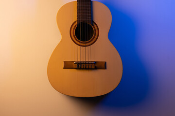Naklejka premium acoustic guitar on a blue and yellow background