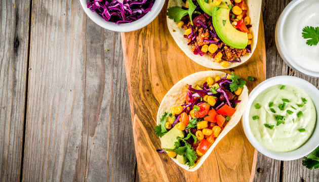 Delectable Tacos Feast: Two vibrant tacos, generously filled with colorful ingredients, accompanied by bowls of fresh sauce and a wooden cutting board, offer a delightful culinary experience.