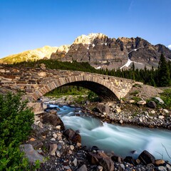 Mountain stone arch bridge over flowing river