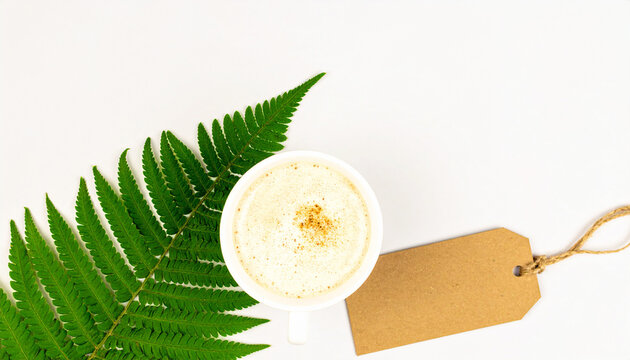 Eco-Friendly Coffee Moment: An overhead view showcases a freshly brewed coffee cup complemented by a vibrant fern leaf and a sustainable tag. It's an invitation to a mindful start to your day.