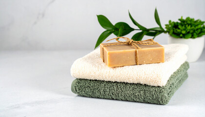 Spa-Day Serenity: A rustic bar of soap rests atop folded towels with the gentle touch of nature, embodying the essence of relaxation and well-being. 