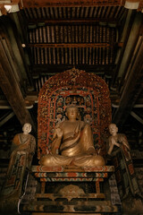 Fototapeta premium Historical Chinese temple featuring intricate sculptures and a prominent Buddha idol