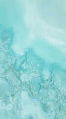 Aerial view of a turquoise coastline with abstract wave patterns and blue tones. 