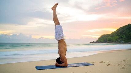 Yoga headstand on beach at sunset - Powered by Adobe