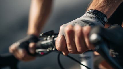 A close-up on a cyclist hands gripping the handlebars, showing the effort and control required.