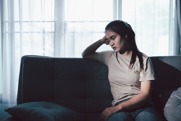 Sorrowful woman sat alone, overwhelmed by emotion, her sad and unhappy expression revealing deep...