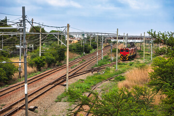locomotive train driving in the junction at a rails node, railways a cheap method to transport goods, locomotive hybrid electric and diesel,