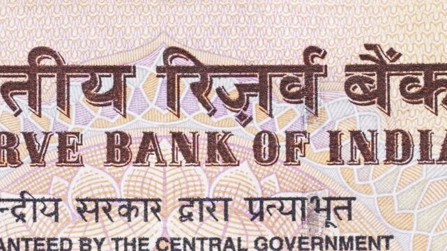 Macro pan over &ldquo;Reserve Bank of India&rdquo; in English and Hindi on a rupee note