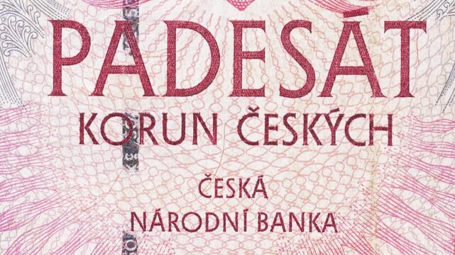 Tilt macro reveal of Czech National Bank text on a Czech koruna note