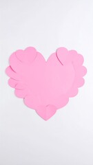 Pink paper heart crafted from smaller hearts, on a white background