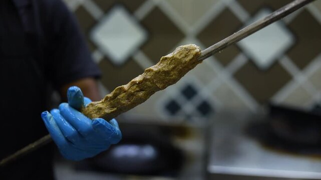 Seekh kebab being made in a kitchen in a restaurant