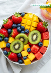 Obraz premium Vibrant fresh fruit salad bursting with strawberries, blueberries, mango, kiwi, and watermelon for healthy eating