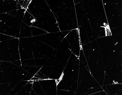 Shattered glass on a black background, intricate web of cracks