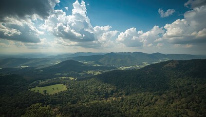 Obraz premium Expansive vista of a mountainous landscape under a dramatic sky.
