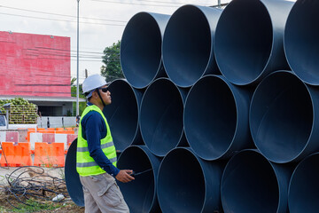 Engineers are inspecting the readiness and completeness of a large construction project involving pipe laying and road construction.Civil engineer,construction,roadconstruction,engineer,drainage pipe.