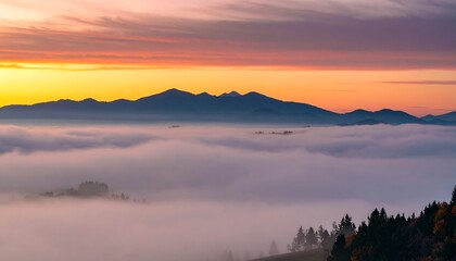 Obraz premium Majestic mountains piercing through a sea of fog under a vibrant sunrise sky painting the horizon