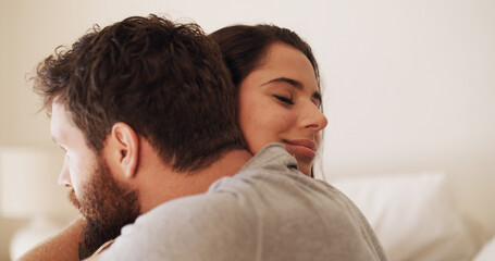 Obraz premium Love, romance and couple with hug in bedroom for affection, bonding together or relationship. Space, smile and people with embrace in home for marriage commitment, protection or loyalty with security