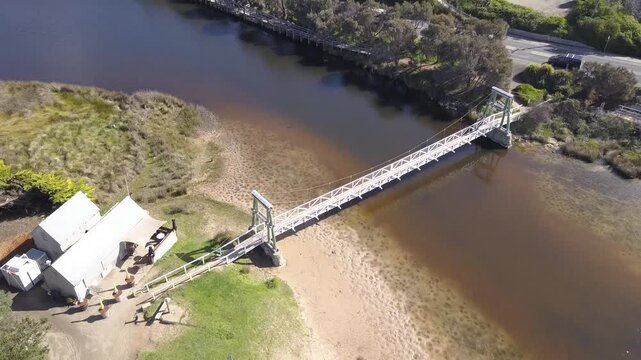 Lorne foreshore Victoria, Aerial view of the swing bridge, Erskine river and waterways. Great Ocean Road capturing rugged coastline, ocean swells, and dense forest on this iconic Australian route - DL
