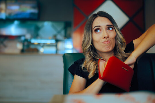 Woman Looking for Money in her Wallet to Pay at a Restaurant. Penniless person having no cash for food in a diner 
