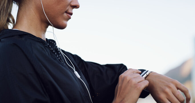 Runner, smart watch and progress with hands and woman for performance stats, location tracking and fitness. Music, stopwatch timer and workout with person and earphones in city for heart rate monitor