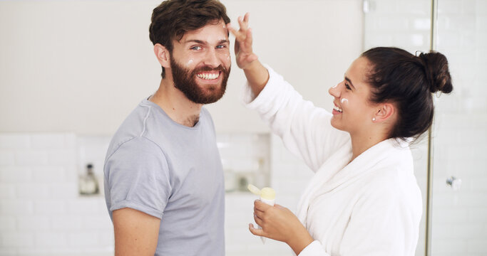Cream, skincare and smile with couple in bathroom of home together for moisturizing routine. Beauty, lotion and portrait with happy people in mirror at apartment for antiaging cosmetics or wellness