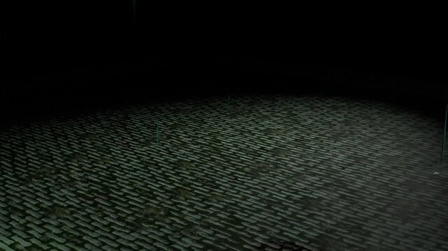 Rainfall environment simulation on a wet sidewalk . Puddel raindrops on the flooded street. Dim streetlight  while pouring rain at night.