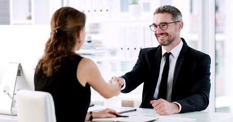 Shaking hands, deal and business people in office with finance agreement, negotiation or meeting. Welcome, smile and financial manager with client for handshake on investment proposal in workplace.