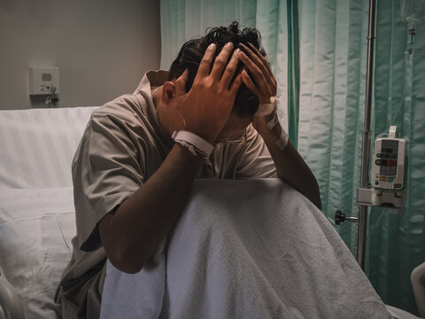 Man with heavy headache in hospital