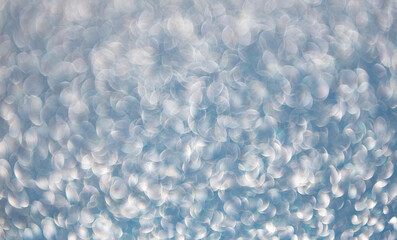 Glitter shimmer background. Defocused shimmer. Bokeh backdrop shimmer. Bokeh effect. Glitter shine. Bokeh shimmering background. Blurred defocused background. Blur glitter backdrop. Glitter sparkles