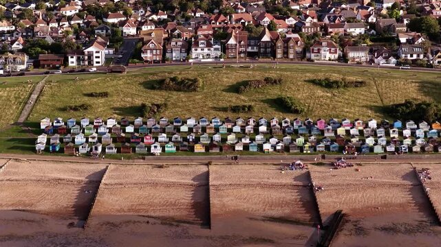 Aerial view of Whitstable Beach with huts and town, sunny calm mood