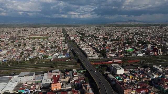 Drone footage of everyday hustle in Ecatepec on a sunny afternoon with gray clouds