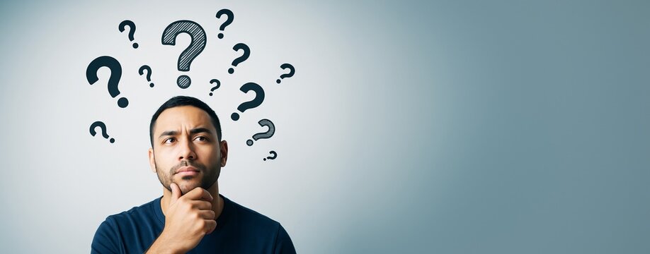 Thoughtful man surrounded by question marks on gradient background with copy space, representing decision making and problem solving concept.