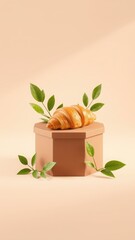 A croissant on a geometric platform with leaves against a peach colored background in soft light